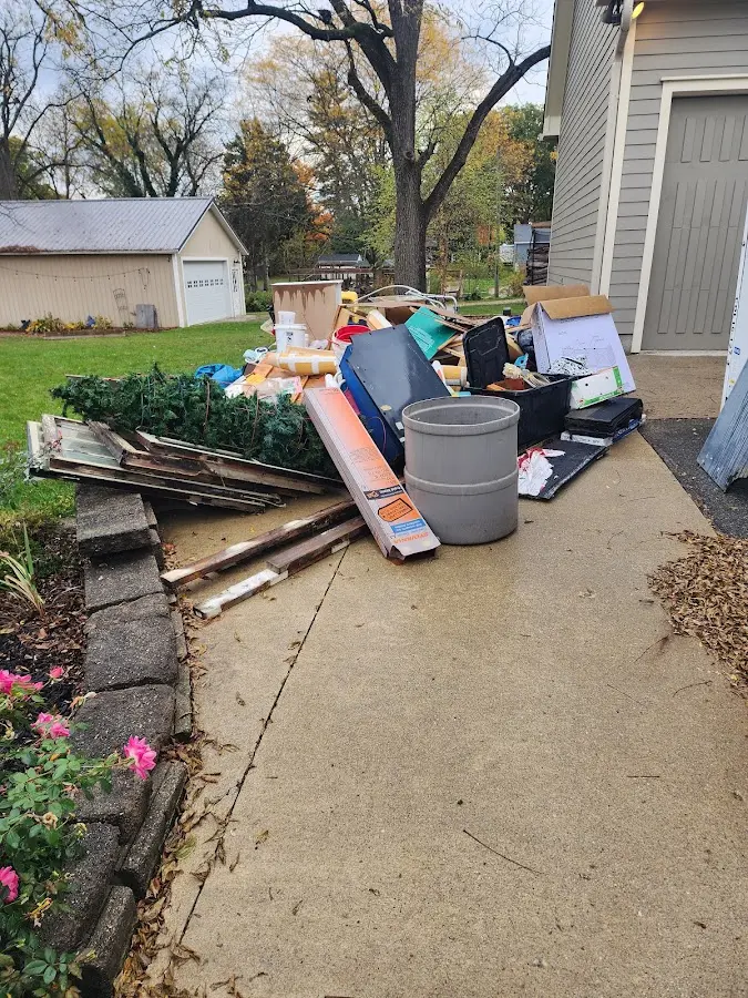Dumpster being loaded with debris for 3 Yard Dumpster Rental in Chatfield